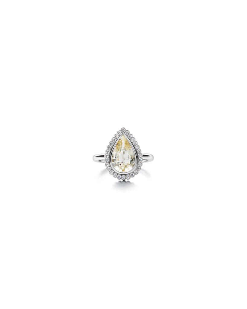 yellow drop-shaped sapphire ring with diamond halo