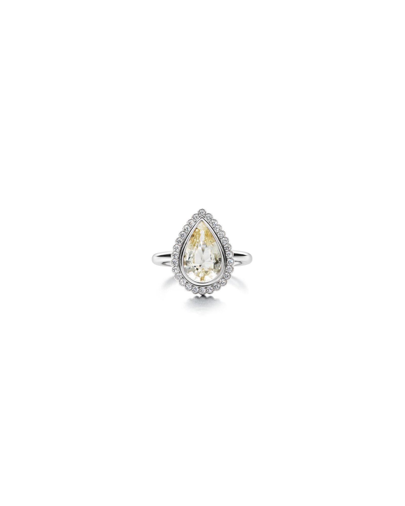 yellow drop-shaped sapphire ring with diamond halo