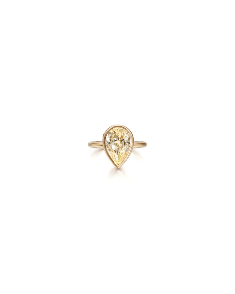 a drop-shaped diamond ring in gold