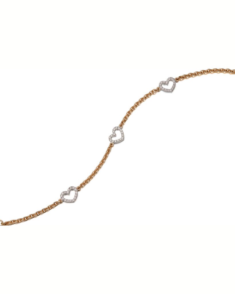 gold chain bracelet with three white gold hearts with diamonds